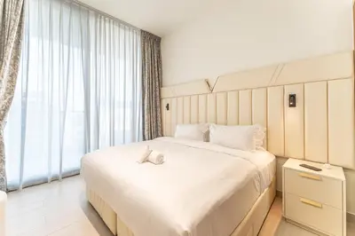 a bedroom with a large bed with two shoes on it at HAVN - New 2 Bedroom in Binghatti Amber, JVC in Dubai