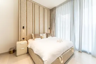 a bedroom with a bed and a large window at HAVN - New 2 Bedroom in Binghatti Amber, JVC in Dubai