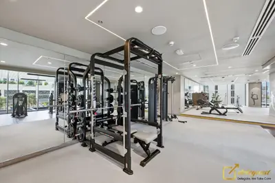 a gym with several tread machines in a room at Premium 1BR with Panoramic Views Creek Harbour Steps from Creek Harbour Walk in Dubai