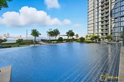 a large swimming pool in the middle of a building at Premium 1BR with Panoramic Views Creek Harbour Steps from Creek Harbour Walk in Dubai