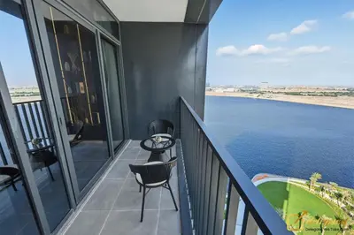 a balcony with a view of the water at Premium 1BR with Panoramic Views Creek Harbour Steps from Creek Harbour Walk in Dubai