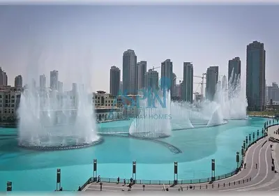 a group of water fountains in front of a city at Aspin 3BR Iconic Burj Khalifa Live Fountain View in Dubai