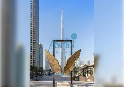 a statue of an eagle in front of a city at Aspin 3BR Iconic Burj Khalifa Live Fountain View in Dubai