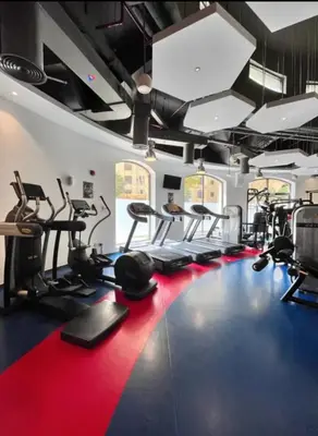 a gym with several treadmills and cardio machines at SettlerHomes - Stunning JBR 2BR Just 5mins To The Beach in Dubai