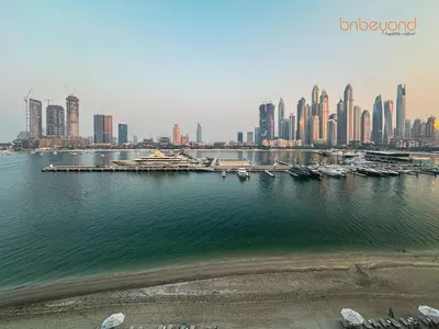 a view of a city with a harbor and buildings at Private Beach and Pool Vibes at Palace Residences in Dubai