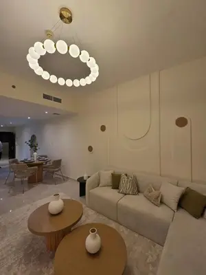a living room with a couch and tables and a chandelier at Duja Tower 4404 in Dubai