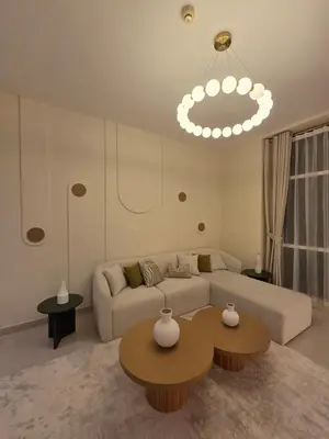 a living room with a couch and two tables at Duja Tower 4404 in Dubai