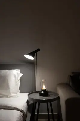 a room with a bed and a table with a candle on it at Elite Escape - Stylish Getaway in Azizi Riviera 43 in Dubai