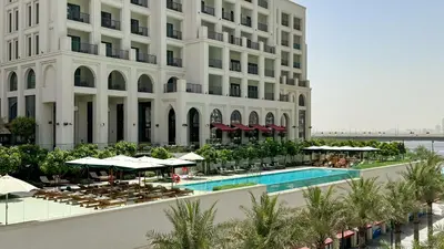 an aerial view of a hotel with a pool and a building at 833keys - 1BR - Lagoon Access - Vida Creek Beach - Creek Harbour - Dubai in Dubai