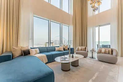 a living room with a blue couch and a table at Duplex Apartment Next to Zabeel Park, Steps from the Metro Station, and Minutes to Downtown Dubai, Al Kifaf 1 Residences East, Bur Dubai, by Deluxe Holiday Homes in Dubai