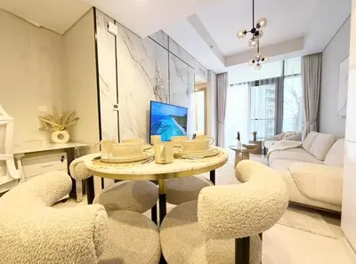 a living room with a table and chairs at Exquisite 2BR With Balcony in Business bay in Dubai