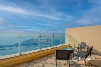 a balcony with a view of the roller coaster at Dream Inn - Timeless Arabic-Inspired Penthouse with Private Pool and Sweeping Ain Dubai Views in Dubai