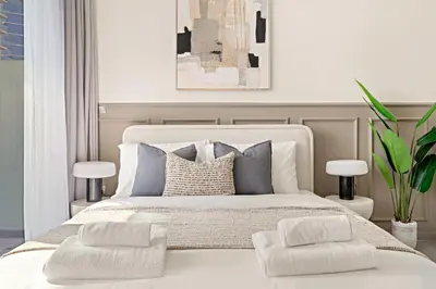 a bedroom with a large white bed with two pillows at Silkhaus Modern 2BR in Merano Tower in Business Bay in Dubai