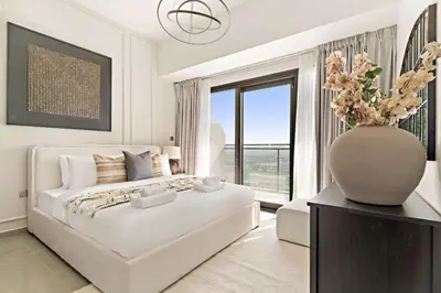 a white bedroom with a large bed and a large window at Silkhaus Modern 2BR in Merano Tower in Business Bay in Dubai