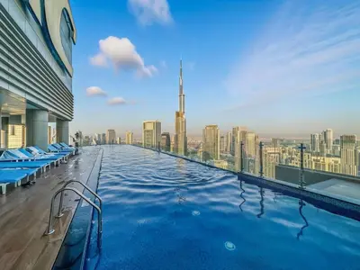 a swimming pool with a view of a city at CH Burj Khalifa View Pool 1BR Paramount Escape in Dubai
