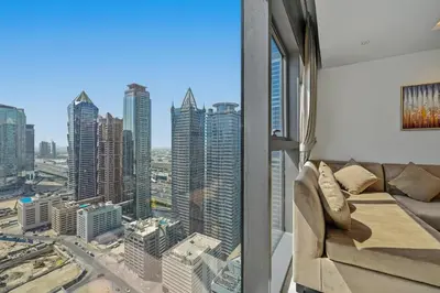 a living room with a view of a city at CH Burj Khalifa View Pool 1BR Paramount Escape in Dubai