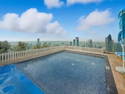 a swimming pool on the roof of a building at CH Burj Khalifa View Pool 1BR Paramount Escape in Dubai