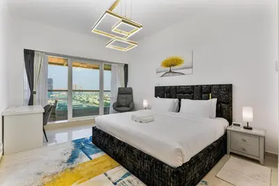 a bedroom with a large bed and a window at Chic 4-Sleeper near JBR Beach & Dubai Marina Mall in Dubai