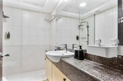 a bathroom with a sink and a shower at Chic 4-Sleeper near JBR Beach & Dubai Marina Mall in Dubai