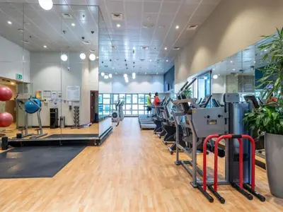 a gym with treadmills and elliptical machines at SkyRise Apartment with Stunning Sea View on 89 Floor in Dubai