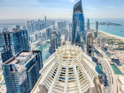 an aerial view of a city with tall buildings at SkyRise Apartment with Stunning Sea View on 89 Floor in Dubai