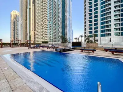 a large swimming pool in a city with tall buildings at SkyRise Apartment with Stunning Sea View on 89 Floor in Dubai