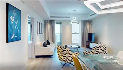 a living room with a glass table and chairs at SkyRise Apartment with Stunning Sea View on 89 Floor in Dubai