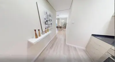 a hallway with white walls and wooden floors and vases at Premium 1BR on High Floor with Stunning Sea View and Balcony in Dubai
