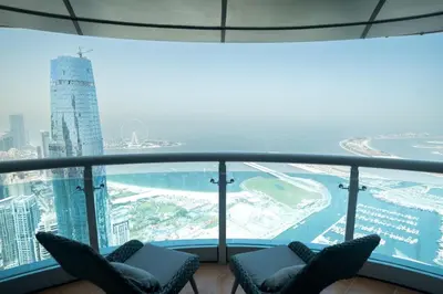 a view from the top of a building with two chairs at Premium 1BR on High Floor with Stunning Sea View and Balcony in Dubai