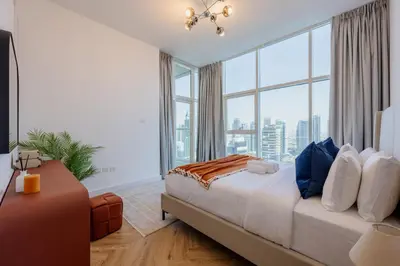 a bedroom with a bed and a large window at Waterfront Serenity in Dubai Marina in Dubai