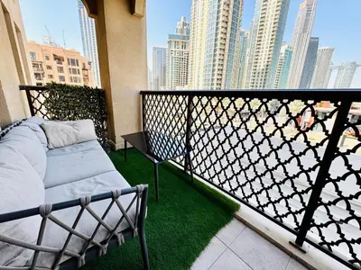 a balcony with a bench and a view of a city at Burj Khalifa View 2 Bed Luxury Apartment in Dubai