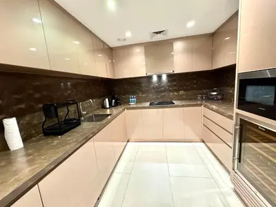 a kitchen with white cabinets and a counter at Burj Khalifa View 2 Bed Luxury Apartment in Dubai