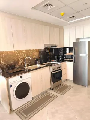 a kitchen with a sink and a stove and a dishwasher at Cozy Modern 1BR with Dubai Skyline View in Dubai