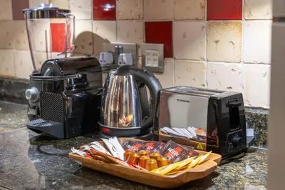 a kitchen counter with a toaster and a basket of food at Full Burj View - Souk vibe one-bedroom apartment in Dubai