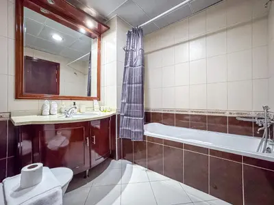 a bathroom with a tub and a toilet and a sink at Opal Tower Condos - Dubai Marina in Dubai