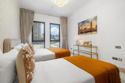 a bedroom with two beds and a window at Sleep 5 Near Dubai Mall in Dubai