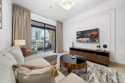 a living room with a couch and a tv at Sleep 5 Near Dubai Mall in Dubai