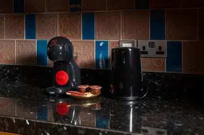 a kitchen counter with a coffee maker on a counter top at Sleep 5 Near Dubai Mall in Dubai