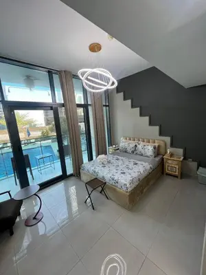 a bedroom with a bed and a staircase at Studio in Business Bay with Huge Balcony & Pool View near to Metro in Dubai