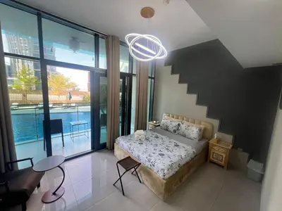 a bedroom with a bed and a large window at Studio in Business Bay with Huge Balcony & Pool View near to Metro in Dubai