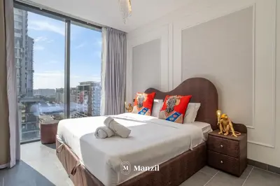 a bedroom with a bed with a large window at Luxury 1BR in Sobha Hartland w Pool & Gym Access in Dubai