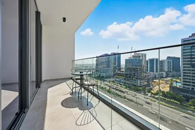 a balcony with a view of a city at New, Bright & Cozy 1BD at Paragon by IGO, Dubai in Dubai