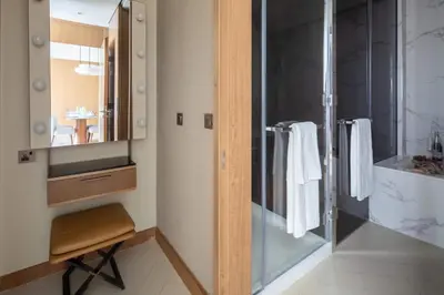 a bathroom with a glass shower and a sink at Frank Porter - Address Opera Tower in Dubai