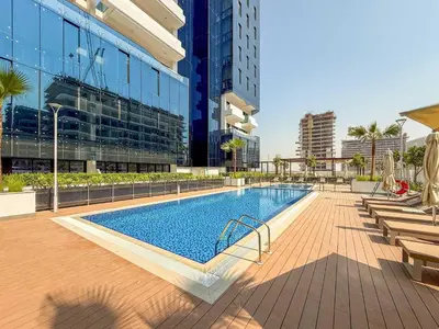 a swimming pool in the middle of a building at Frank Porter - Azizi Riviera 51, Meydan in Dubai
