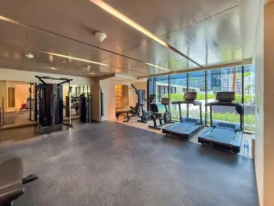 a gym with several treadmills and machines in a room at Frank Porter - Azizi Riviera Azure, Meydan in Dubai