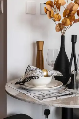 a table with vases and a plate on a table at Frank Porter - Azizi Riviera Azure, Meydan in Dubai