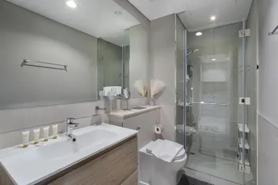 a bathroom with a toilet and a sink and a shower at Zada Tower, Business Bay - 1 Bedroom - Allsopp & Allsopp in Dubai
