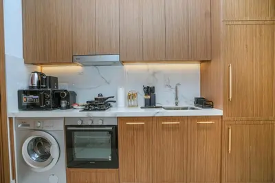 a kitchen with a sink and a washing machine at NEW! Studio in Azizi Riviera 59 in Dubai