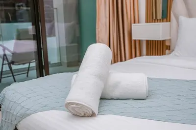 a roll of toilet paper sitting on a bed at NEW! Studio in Azizi Riviera 59 in Dubai