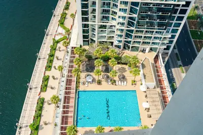 an aerial view of a building with a swimming pool at Full Canal Views, Minutes from Downtown and Burj Khalifa, Close to Metro Station - Prive By Damac B, Business Bay by Deluxe Holiday Homes in Dubai